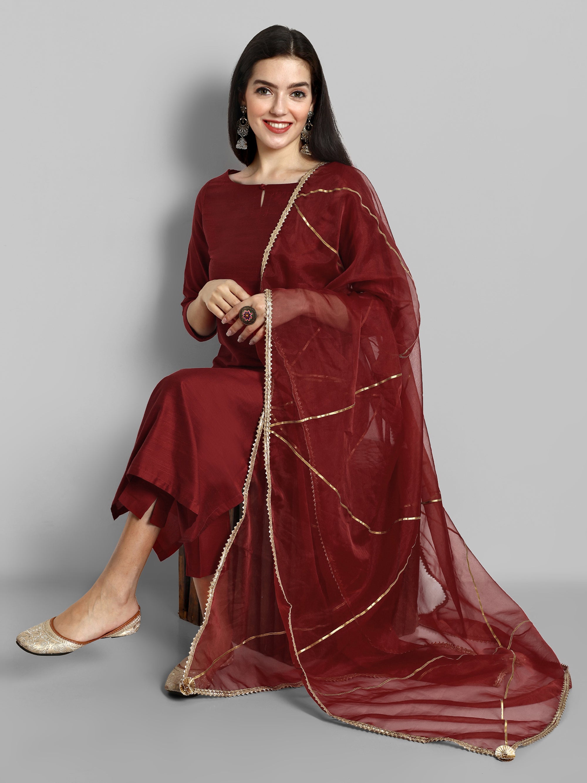 Maroon boat neck kurta paired with elasticated pants and an organza dupatta - a stylish set of three for a sophisticated and coordinated look