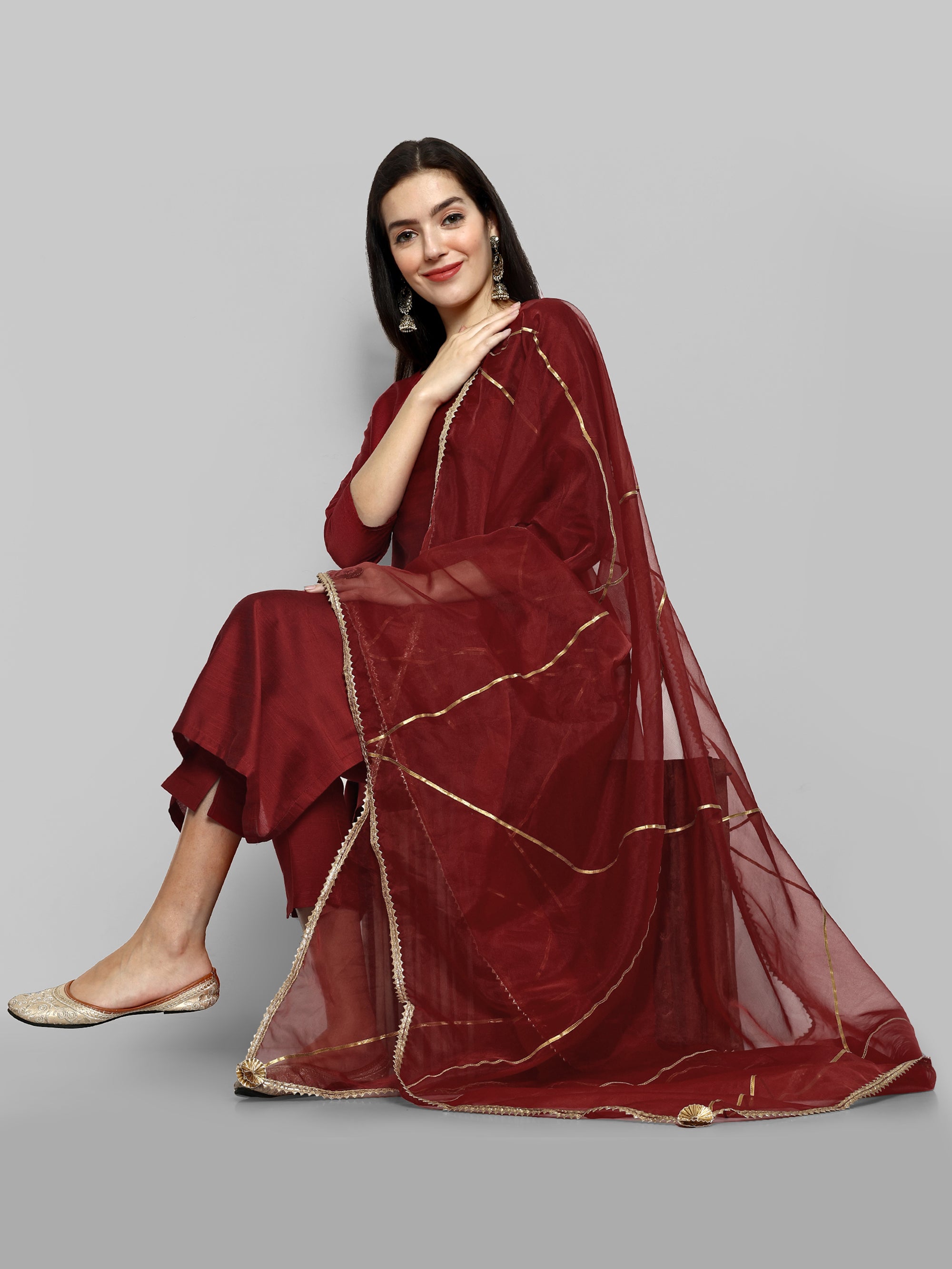 Maroon boat neck kurta paired with elasticated pants and an organza dupatta - a stylish set of three for a sophisticated and coordinated look