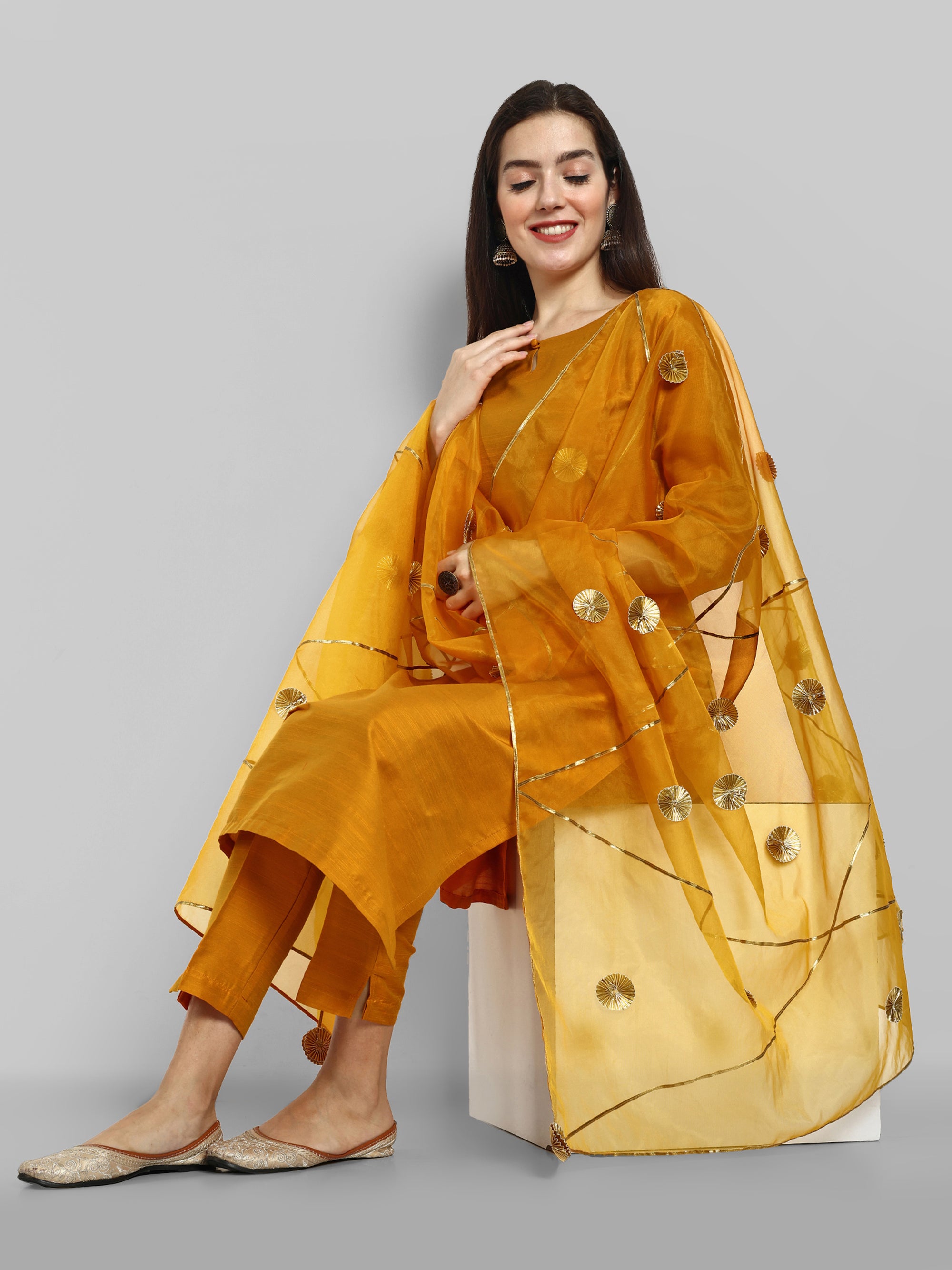 Mustard key hole boat neck kurta paired with elasticated pants and an organza dupatta - a stylish set of three for a sophisticated and coordinated look